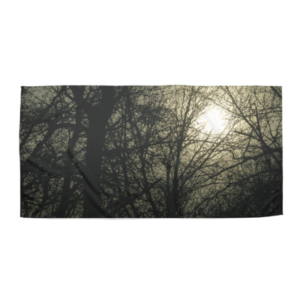 Beach towel photo of the sun behind a tree | Opposite Home